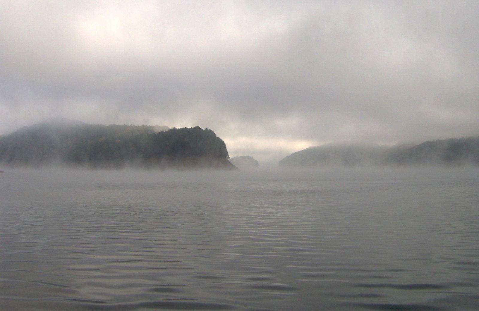 Morning light on Fontana Lake in Swain County, North Carolina, with forested ridges beyond the water. Landscape reference, not a Mountain and Lake Construction home.